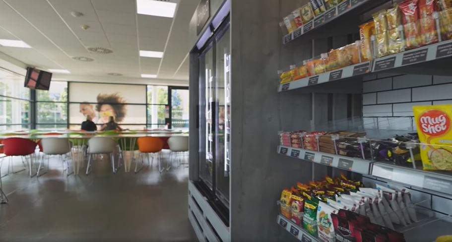 Employees using a self-checkout micro market in a Texas workplace
